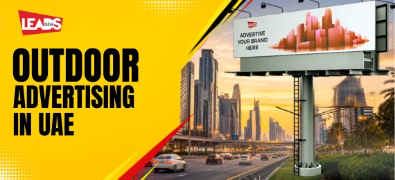 Illuminated highway billboard reading Outdoor Advertising and Your Ad Here, above a city street in Dubai at night